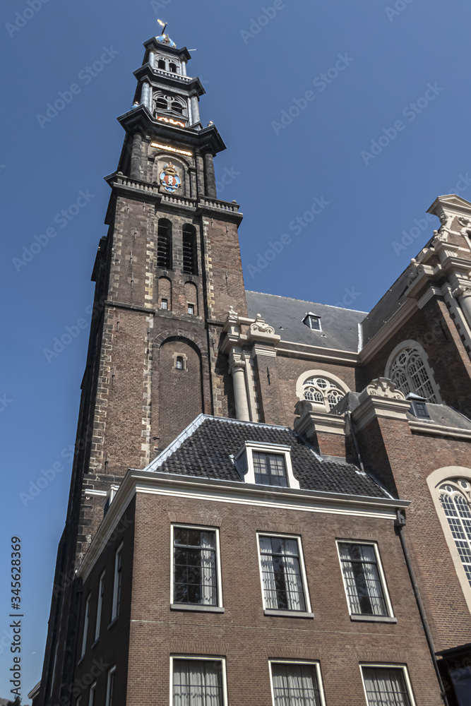 Fototapeta premium View of Western Church (Westerkerk, 1620 - 1631) - a Dutch Protestant church in Amsterdam. It lies in the most western part of the Grachtengordel neighborhood. Amsterdam, Netherlands.