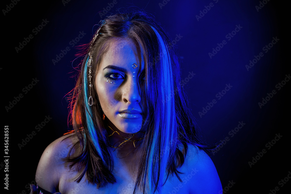 ethnic girl on a black background in blue light ethnic girl on a black background in blue light