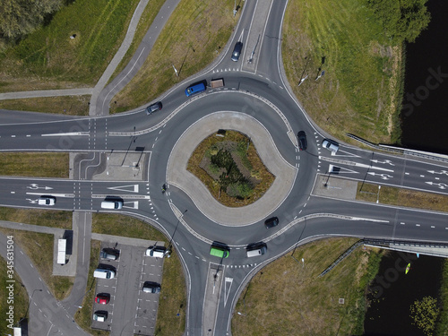 Aerial top down view of a traffic roundabout on a main road in an urban area of the Netherlands