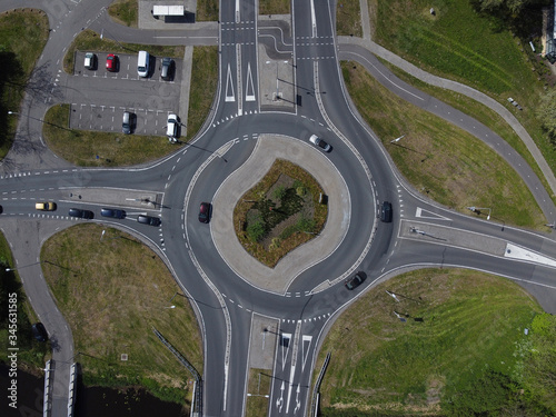 Aerial top down view of a traffic roundabout on a main road in an urban area of the Netherlands