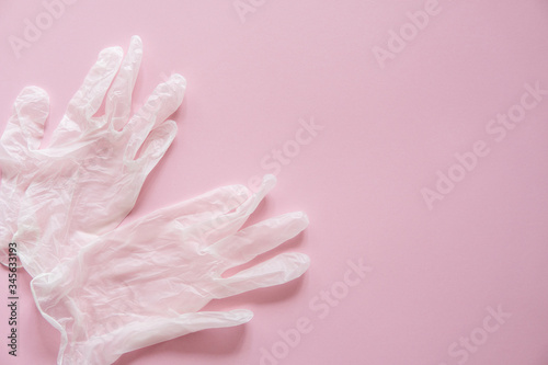 Rubber gloves lie on a pink background. Anti-virus protection kit against covid-19. Coronavirus pandemic 2019.