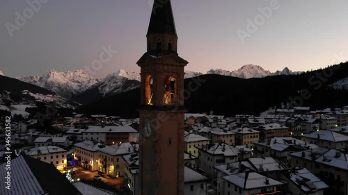 Drone pan around village church at sunset 