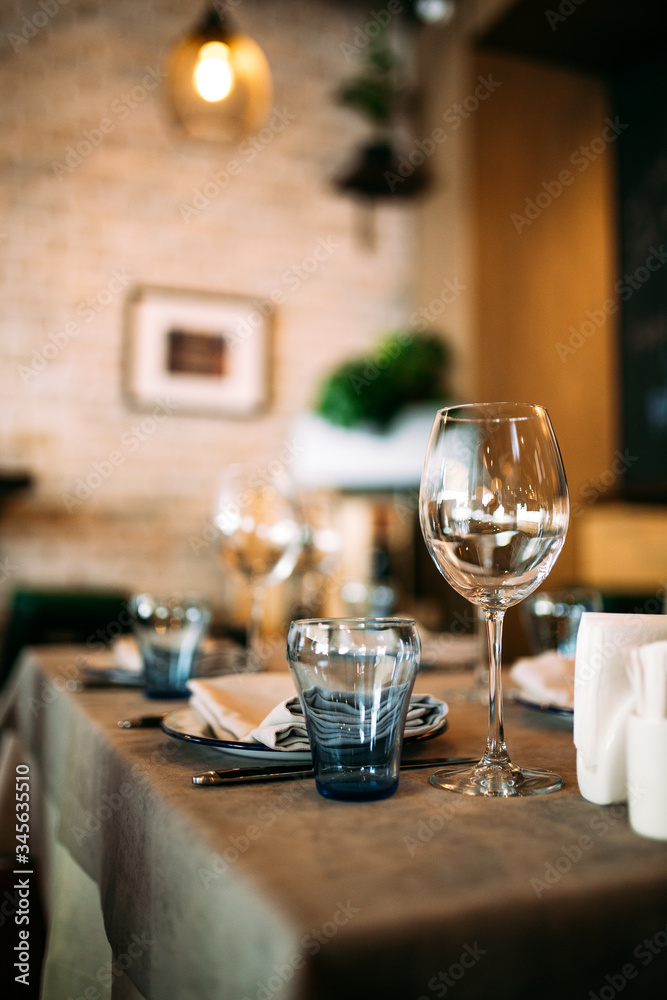 Restaurant glass tableware on the table interior Restaurant glass tableware on the table interior