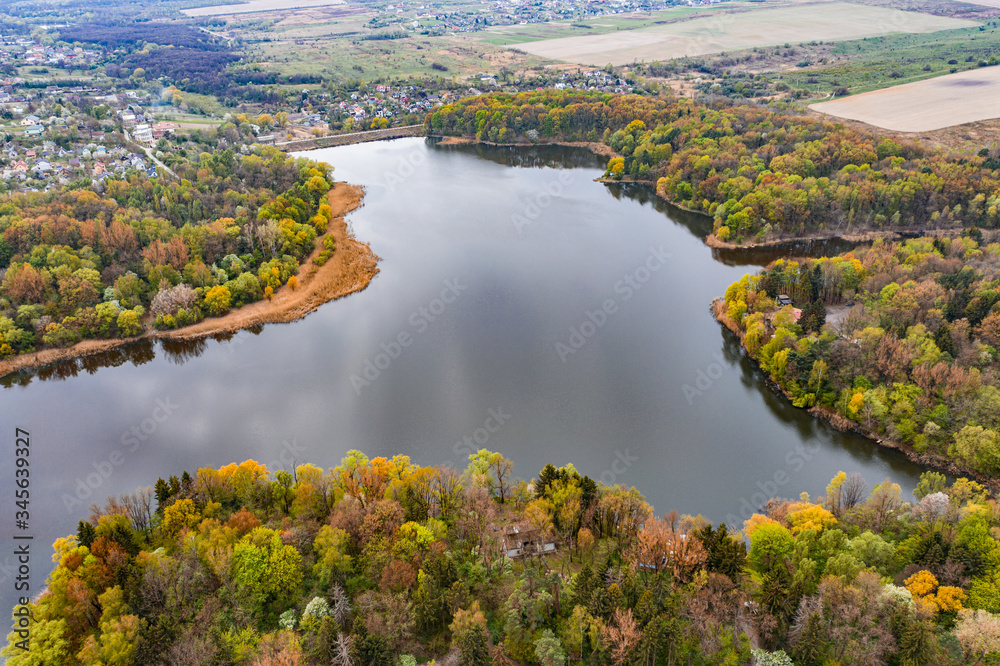 Aerial view on Navariya Lake (Shchyrka Reservoir), forest and field from drone