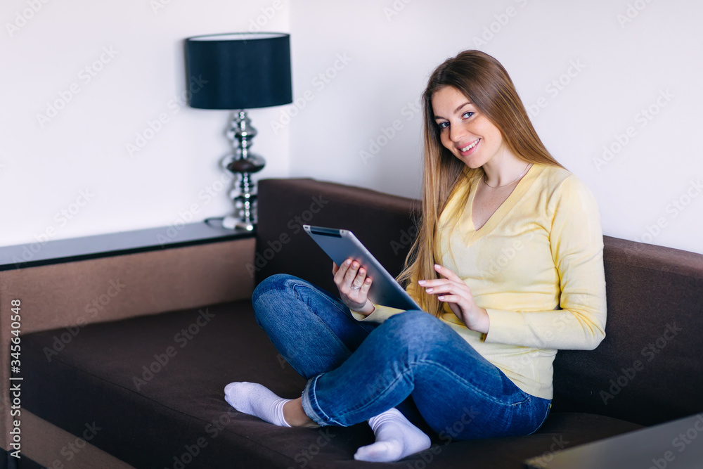 Chilling gorgeous freelancer on the beige couch at home doing on Chilling gorgeous freelancer on the beige couch at home doing on