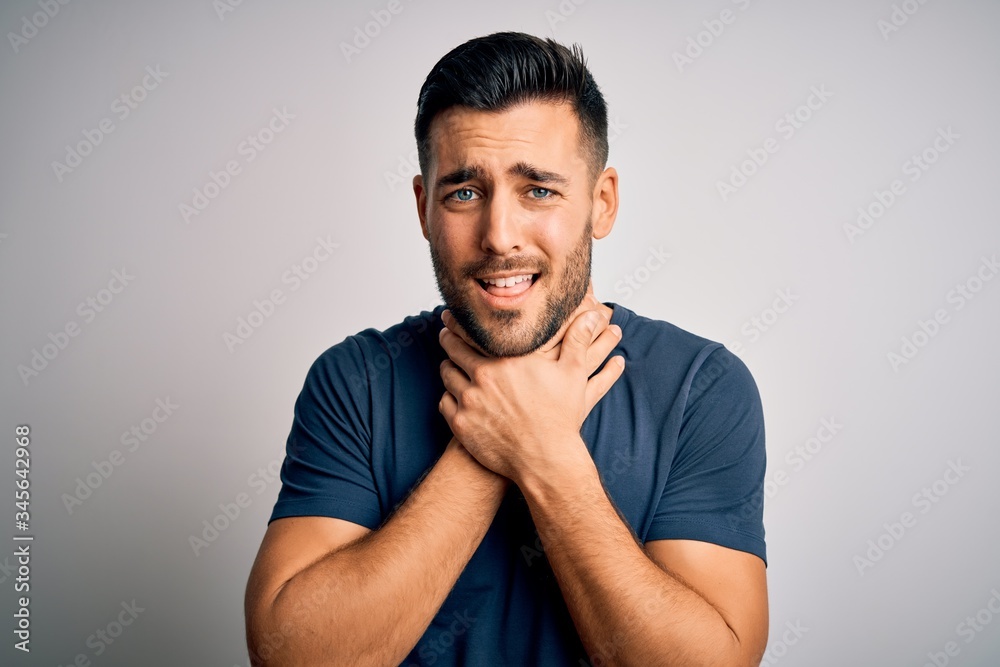 Fototapeta premium Young handsome man wearing casual t-shirt standing over isolated white background shouting and suffocate because painful strangle. Health problem. Asphyxiate and suicide concept.