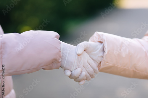Handshake. A woman shaking hands in disposable medical glove wit