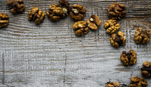 Walnut scattered on the wooden vintage table. Walnuts is a healthy vegetarian protein nutritious food. Walnut on rustic old wood. Copy space.