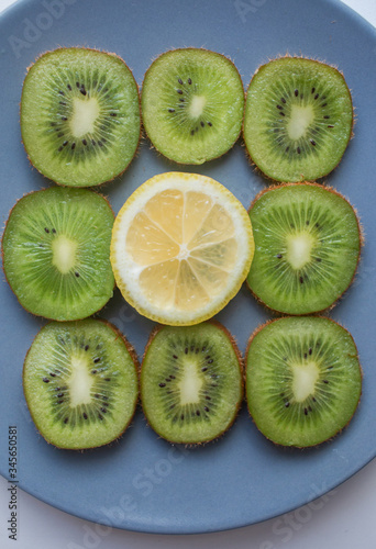 green kiwi and yellow lemon on grey background