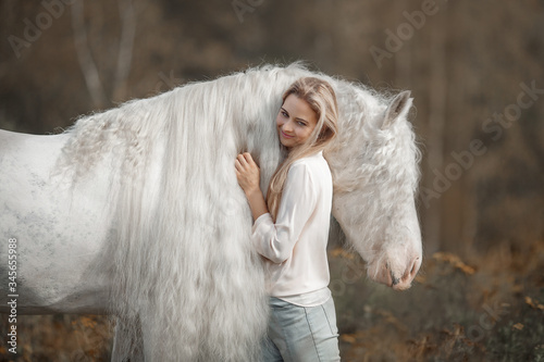 Wallpaper Mural Beautiful young woman with white tinker cob in an autumn field Torontodigital.ca