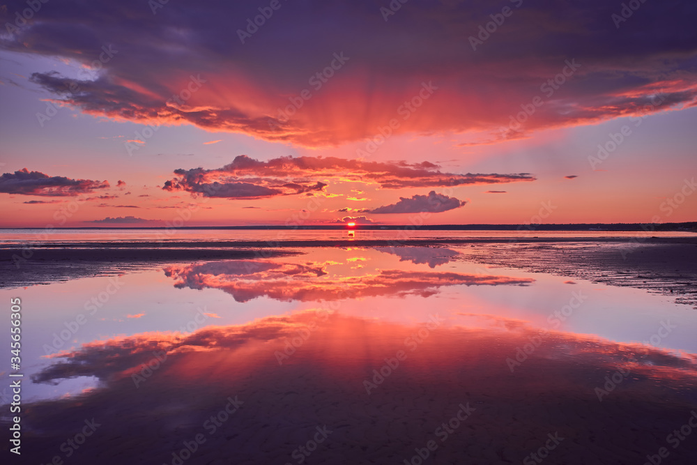 Dramatic reflection of the sky during red sunset.