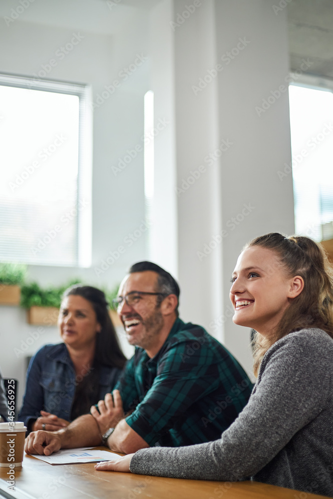Beautiful smiling caucasian business woman siting in boardroom meeting with coworkers with copy space Beautiful smiling caucasian business woman siting in boardroom meeting with coworkers with copy space