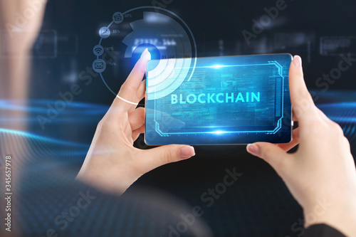 Business, Technology, Internet and network concept. Young businessman working on a virtual screen of the future and sees the inscription: Blockchain
