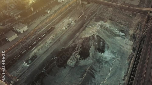 Industry manufacturing excavator loading a train aerial video 4K. photo