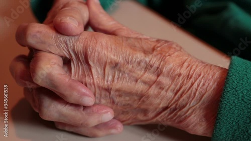 wrinkled hands of old woman, detail of old lady skin

