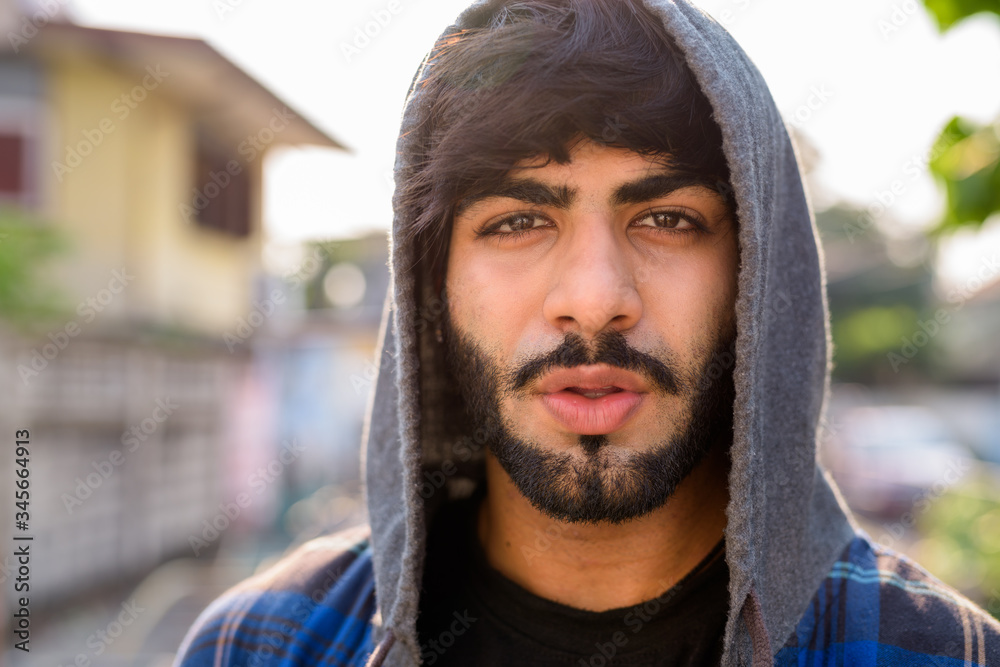 Young handsome bearded Indian hipster man in the city streets Young handsome bearded Indian hipster man in the city streets