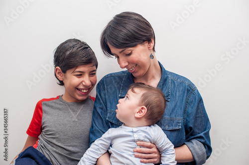 happy mom with her children in a white background.