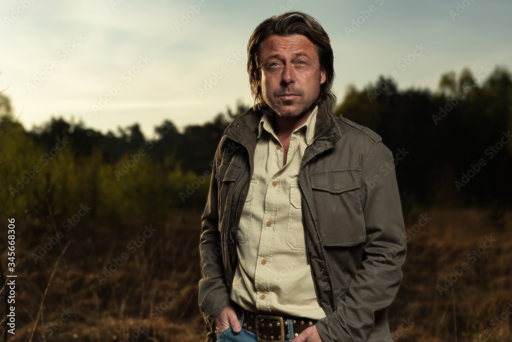 Man in green jacket and shirt in nature reserve at sunrise during spring. Man in green jacket and shirt in nature reserve at sunrise during spring.
