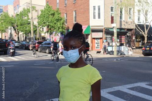 Girl Wearing Surgical ace mask on city street outdoors photo