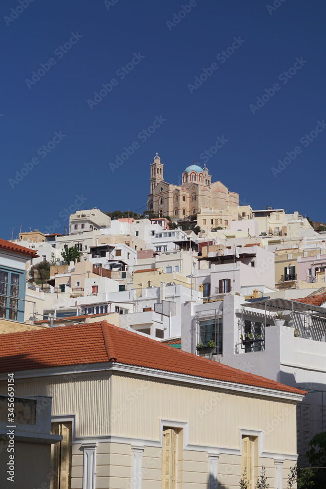 Syros, Greece: The Cathedral of Saint George rises above the houses on a hill in the town of Ano Syros.