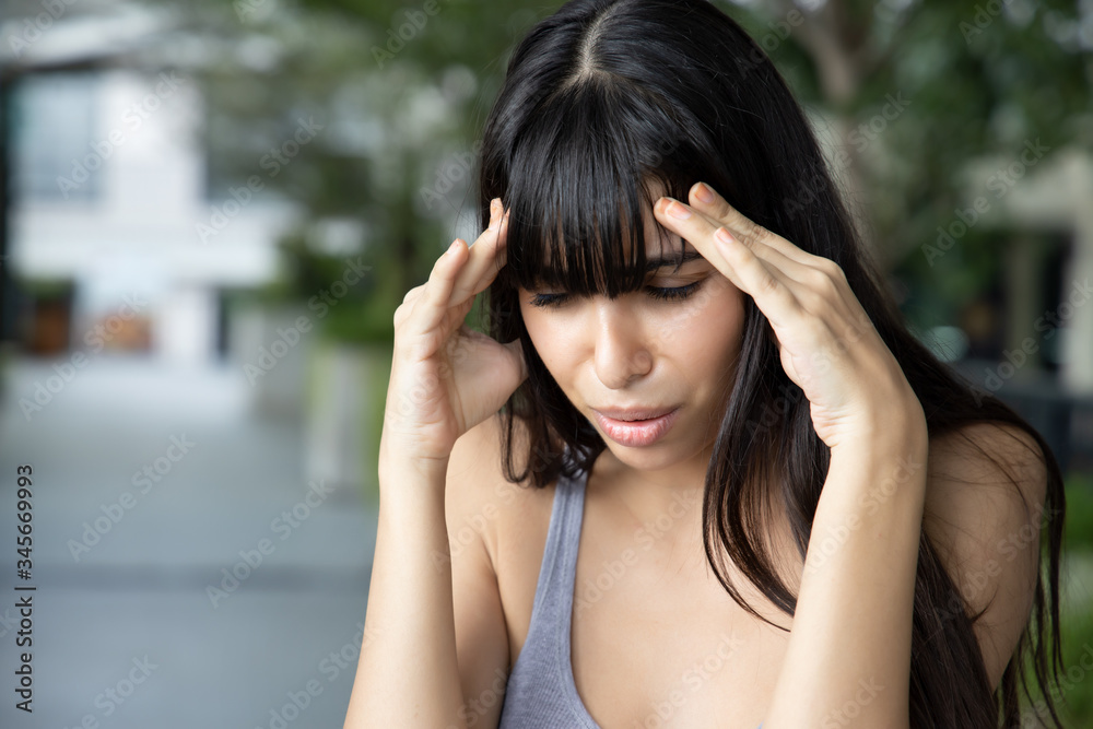 sick woman having headache fever; concept of health care, flu virus infection, disease quarantine, coronavirus, sickness symptoms, COVID-19 coronavirus; South American or latin American woman model sick woman having headache fever; concept of health care, flu virus infection, disease quarantine, coronavirus, sickness symptoms, COVID-19 coronavirus; South American or latin American woman model