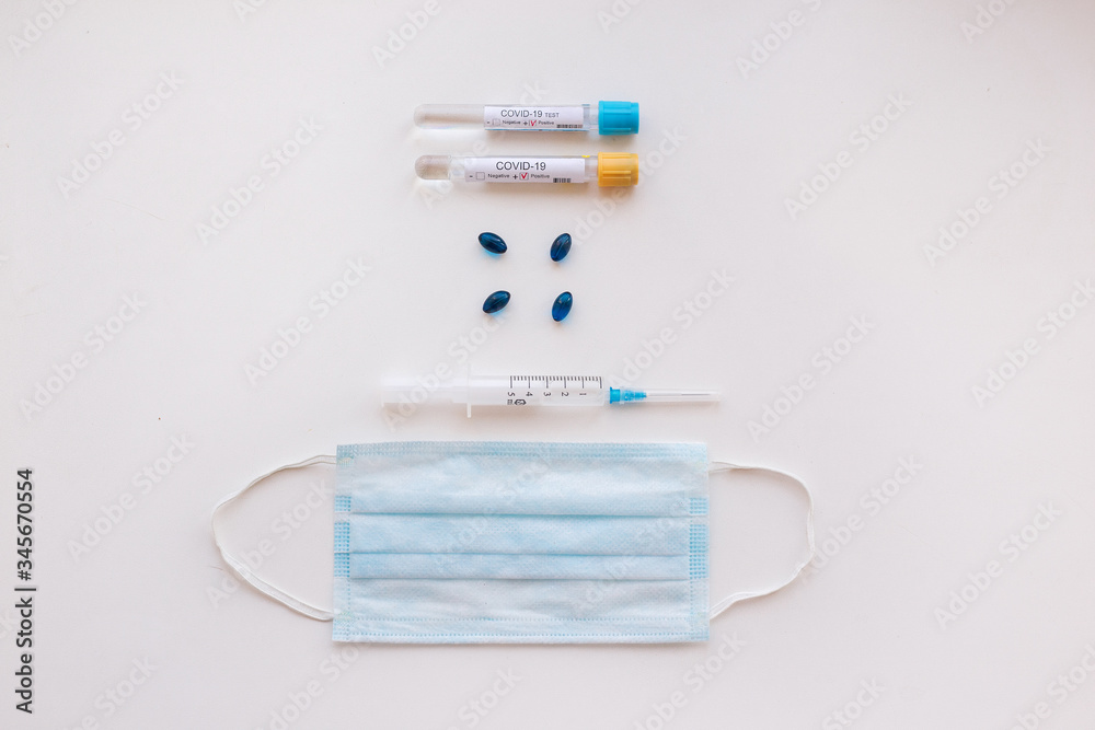 Top view desk in hospital with Coronavirus test tubes with patients blood, pills and respiratory mask. Top view desk in hospital with Coronavirus test tubes with patients blood, pills and respiratory mask.