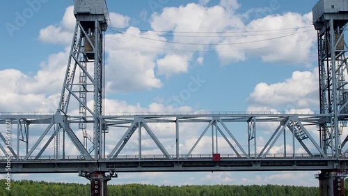 Motor ship approaches the railway bridge over the river