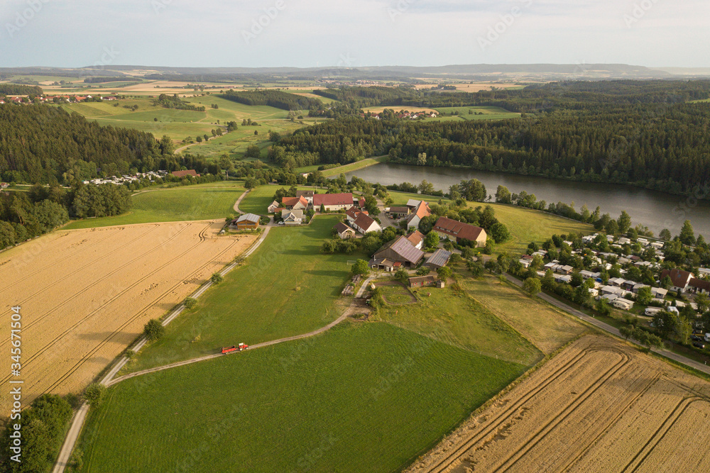 Aerial view of tractor driving to farm in Haselbach