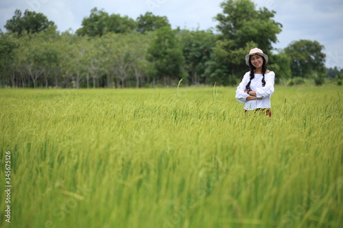 A woman standing in a rice field in Rayong, Thailand