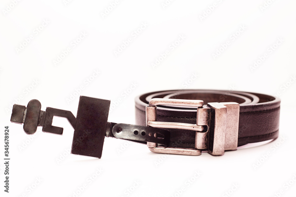 Close-up new classic men's brown leather belt on a white background. Close-up new classic men's brown leather belt on a white background.