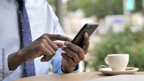 Close Up of African Hand Using Smartphone