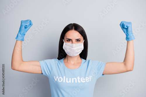 Close-up portrait of her she nice attractive lovely strong powerful girl medic doc voluntary work worker job demonstrating muscles save planet globe isolated over grey pastel color background