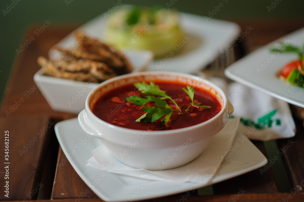 Vegan borscht in bowls on an old wooden background