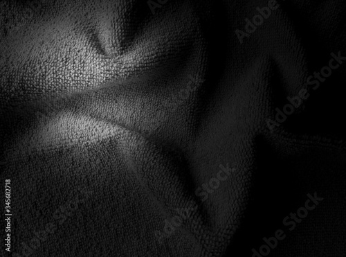 Dark tone folded cotton fabric texture, black and white cloth background