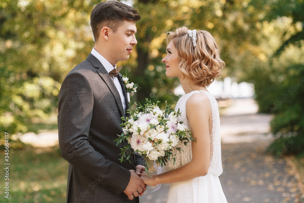 Bride and groom. Portrait of a man in a suit and a woman of a blonde in a white dress on nature on the wedding day. Bride and groom. Portrait of a man in a suit and a woman of a blonde in a white dress on nature on the wedding day.