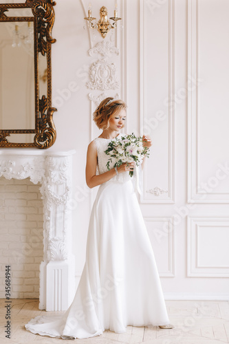 Portrait of the bride. Young girl, blonde with a short haircut. Full growth plan, vintage. Posing beautifully.