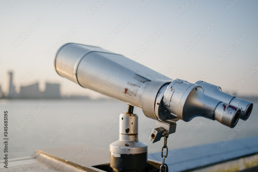 telescope with city skyline