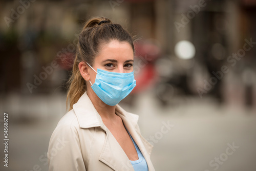 girl with medical mask walks down the street