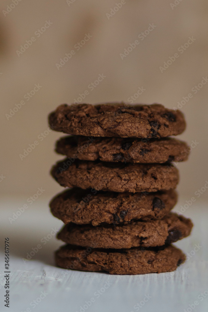 Stack of chocolate chip cookie on white wooden table Stack of chocolate chip cookie on white wooden table