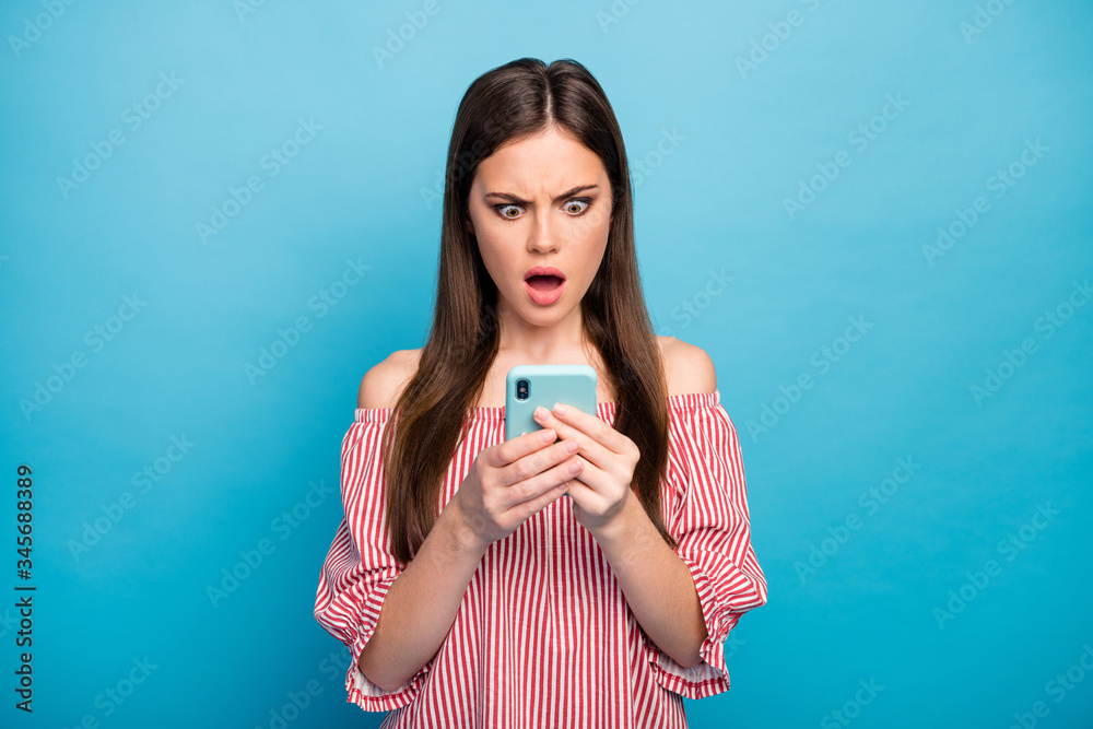 Close-up portrait of her she nice attractive lovely pretty stunned outraged long-haired girl using cell smm dislike reaction isolated over bright vivid shine vibrant blue color background Close-up portrait of her she nice attractive lovely pretty stunned outraged long-haired girl using cell smm dislike reaction isolated over bright vivid shine vibrant blue color background