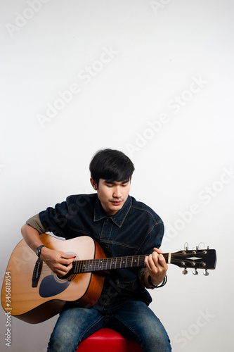 The acoustic guitarist is holding the guitar. And playing guitar Concepts of hobbies and relaxation in free time for good quality of life