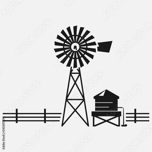 Traditional American water well windmill black and white vector icon. photo