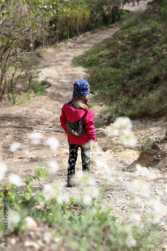 Family walk or hike through the mountain forest in early spring