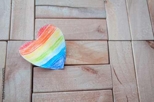 Symbol LGBT. Rainbow heart on a wooden background. Freedom Flag. International Day Against Homophobia.