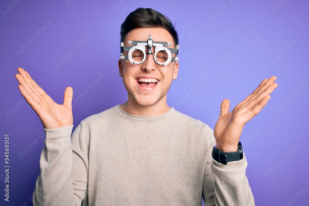 Young handsome caucasian man wearing optometrical glasses over purple background celebrating mad and crazy for success with arms raised and closed eyes screaming excited. Winner concept Young handsome caucasian man wearing optometrical glasses over purple background celebrating mad and crazy for success with arms raised and closed eyes screaming excited. Winner concept