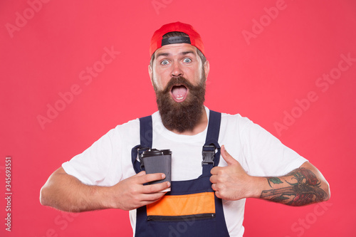 Mechanic enjoy coffee. Coffee helps enhance productivity levels, increases focus, and lowers stress levels at work. Handsome builder hold coffee cup. Is Coffee Break the Best Part of Your Day