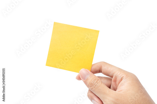 Close up hand holding empty yellow paper note isolated on white background with clipping path. remind to do list, office supplies note message, office and bussiness concept.