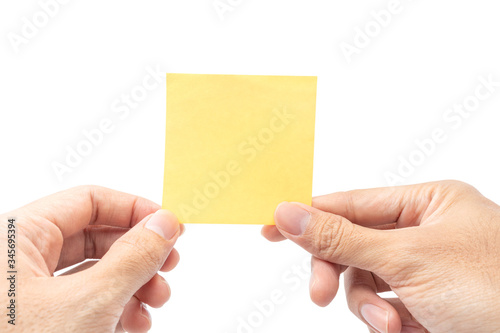 Close up hand holding empty yellow paper note isolated on white background with clipping path. remind to do list, office supplies note message, office and bussiness concept.