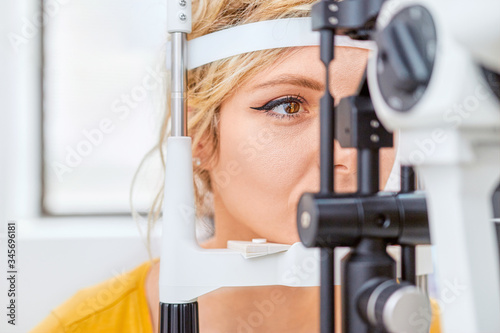 Fototapeta Naklejka Na Ścianę i Meble -  Checking eyesight with Slit lamp, examination of the eyes in an ophthalmology clinic