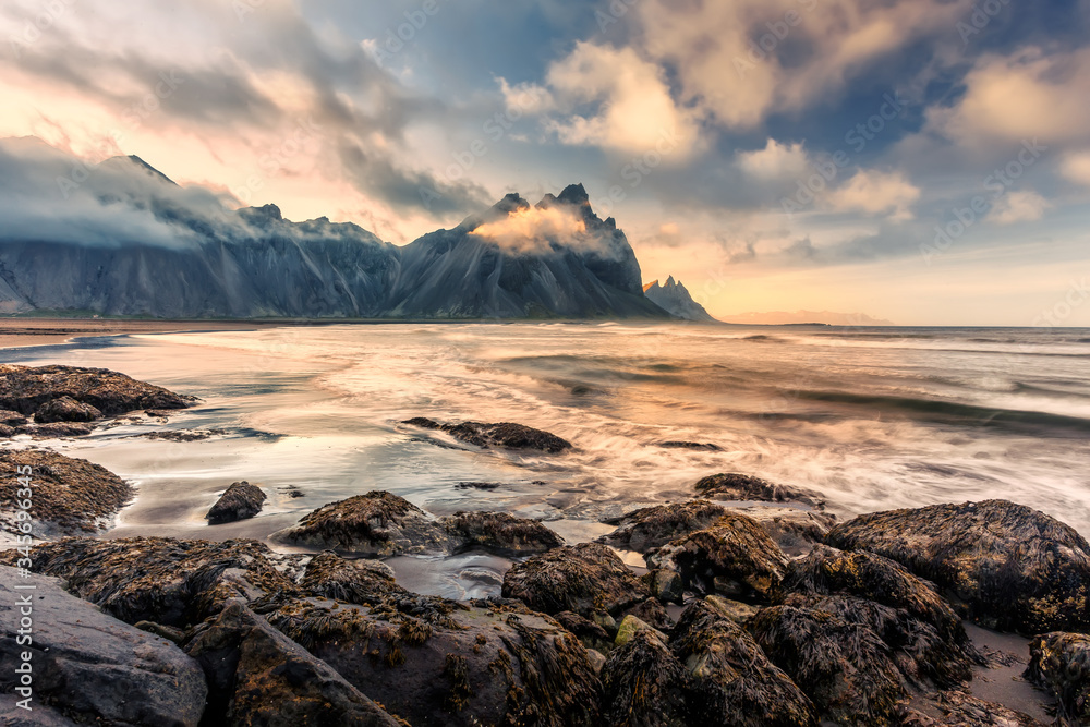 Obraz premium Icelandic Seascape. Wonderful Evening landscape of Vestrahorn Iceland at Stokksnes on the southeastern Icelandic coast. Iceland, Europe. Amazing nature Scenery. Popular Travel destinations